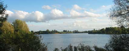 clouds across a reservoir in June