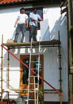 builders applying external wall insulation