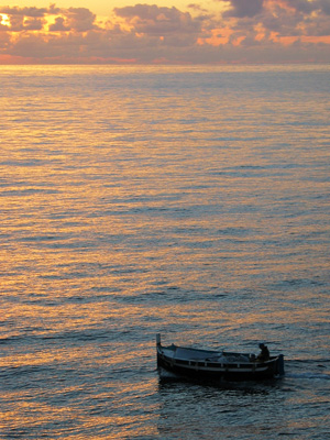 small fishing boat at sunset