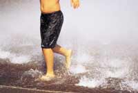 child splashing feet in water